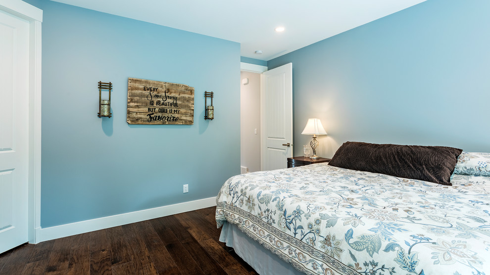 Design ideas for a mid-sized traditional master bedroom in Vancouver with blue walls, medium hardwood floors and brown floor.