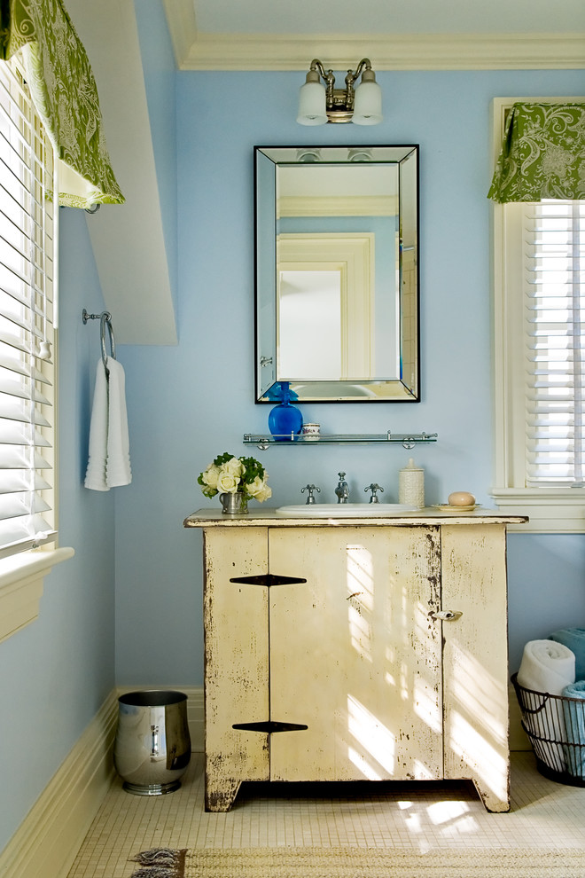 Country bathroom in New York with mosaic tile, a drop-in sink and blue walls.