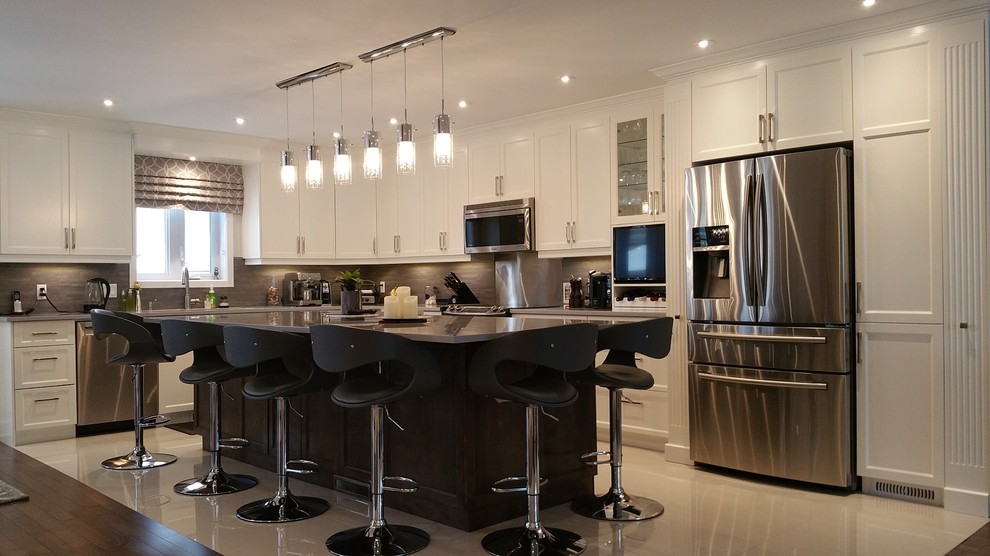 Design ideas for a large contemporary l-shaped open plan kitchen in Montreal with a double-bowl sink, shaker cabinets, white cabinets, granite benchtops, grey splashback, matchstick tile splashback, stainless steel appliances, ceramic floors, with island and grey floor.