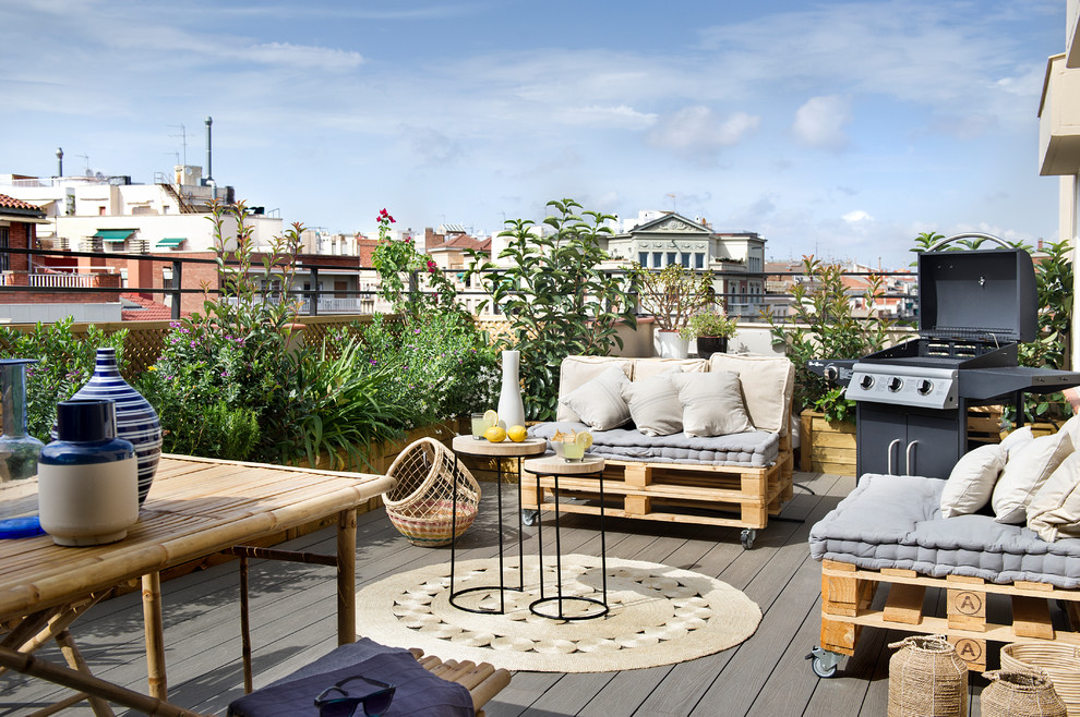 Design ideas for a mid-sized contemporary rooftop and rooftop deck in Barcelona with a fire feature and no cover.