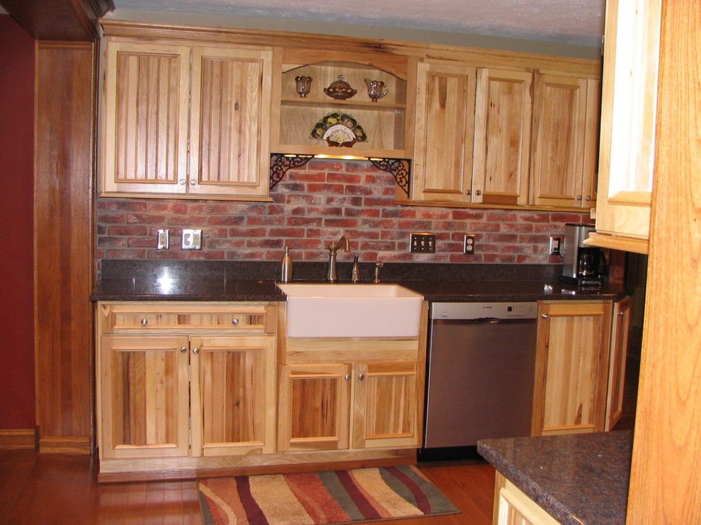 Eat-in kitchen - mid-sized rustic single-wall medium tone wood floor and brown floor eat-in kitchen idea in Chicago with recessed-panel cabinets, distressed cabinets, quartz countertops, brown backsplash, brick backsplash, stainless steel appliances, no island and a farmhouse sink