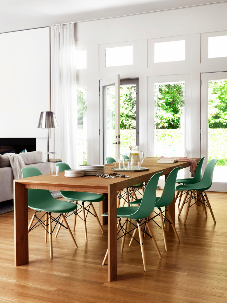 Photo of a transitional open plan dining with white walls, medium hardwood floors and brown floor.