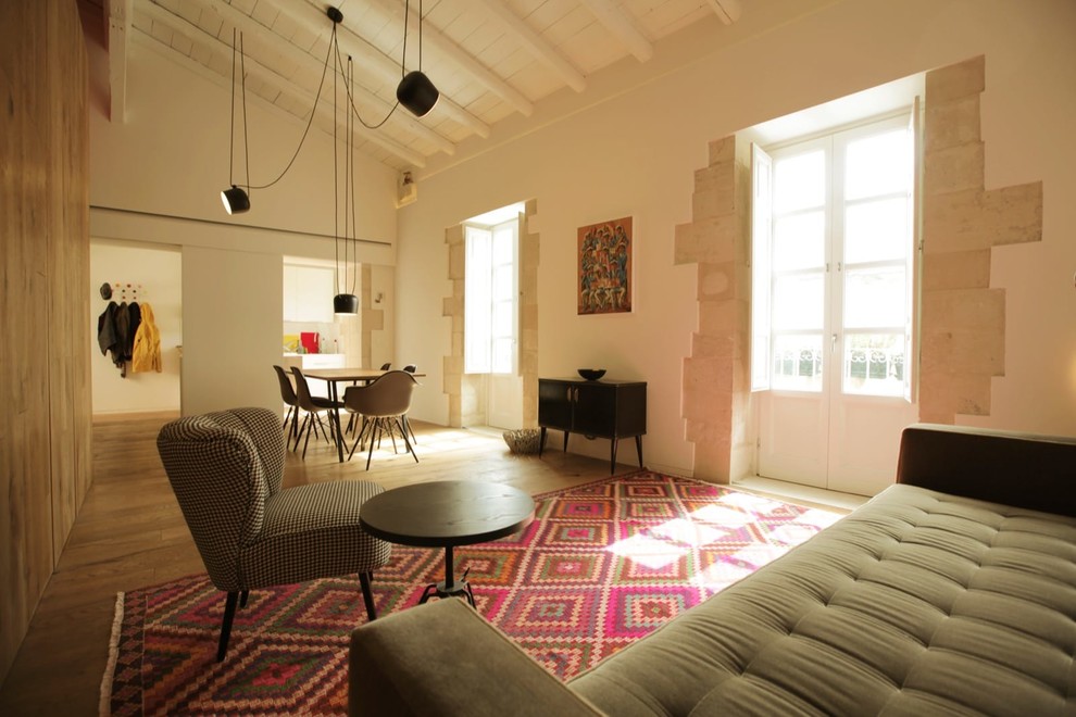Photo of a contemporary living room in Catania-Palermo with light hardwood floors.