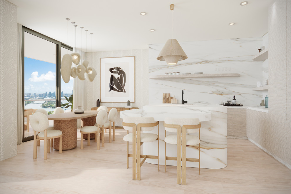 Inspiration for a large modern l-shaped kitchen/diner in Miami with a belfast sink, flat-panel cabinets, beige cabinets, marble worktops, white splashback, marble splashback, integrated appliances, light hardwood flooring, an island, beige floors and white worktops.