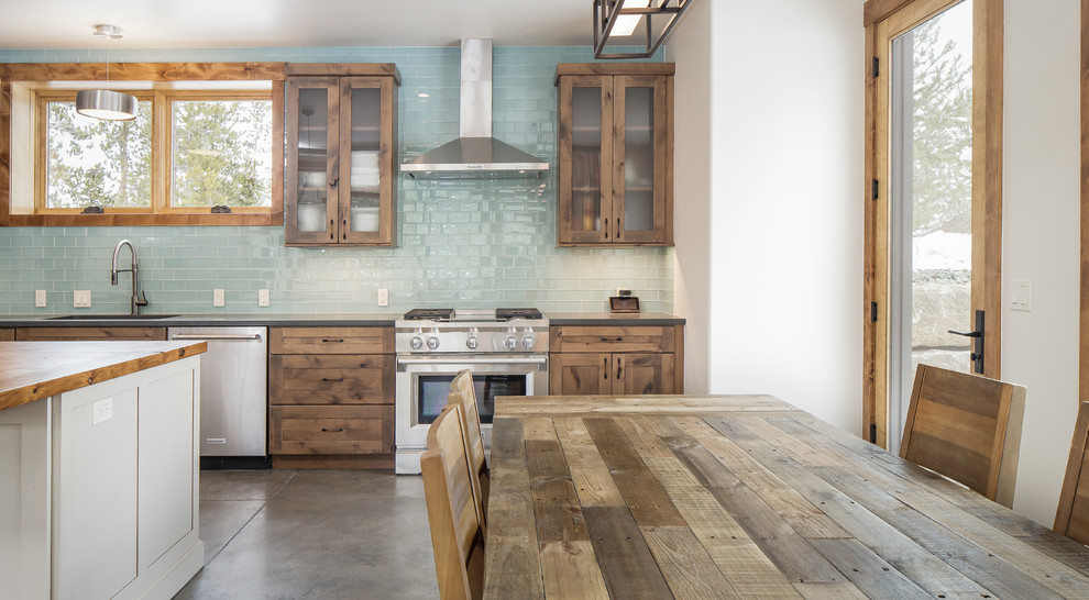 Mid-sized mountain style single-wall eat-in kitchen photo in Denver with an undermount sink, shaker cabinets, distressed cabinets, quartz countertops, blue backsplash, glass tile backsplash, stainless steel appliances, an island and gray countertops