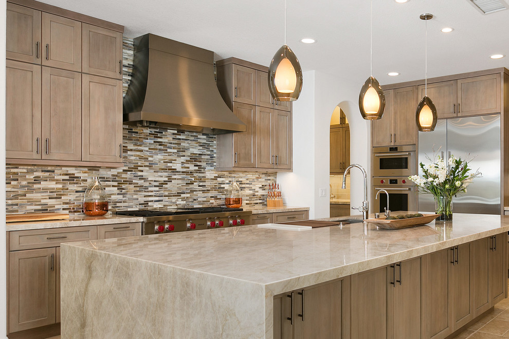 Inspiration for an expansive transitional l-shaped kitchen in Tampa with an undermount sink, quartzite benchtops, multi-coloured splashback, glass tile splashback, stainless steel appliances, porcelain floors, with island, beige floor, grey benchtop, shaker cabinets and medium wood cabinets.