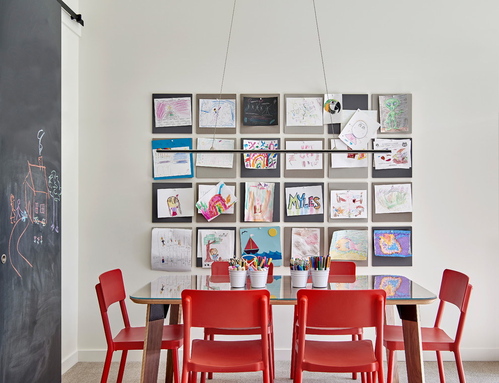 This is an example of a mid-sized contemporary gender-neutral kids' room for kids 4-10 years old in Chicago with white walls, carpet and beige floor.