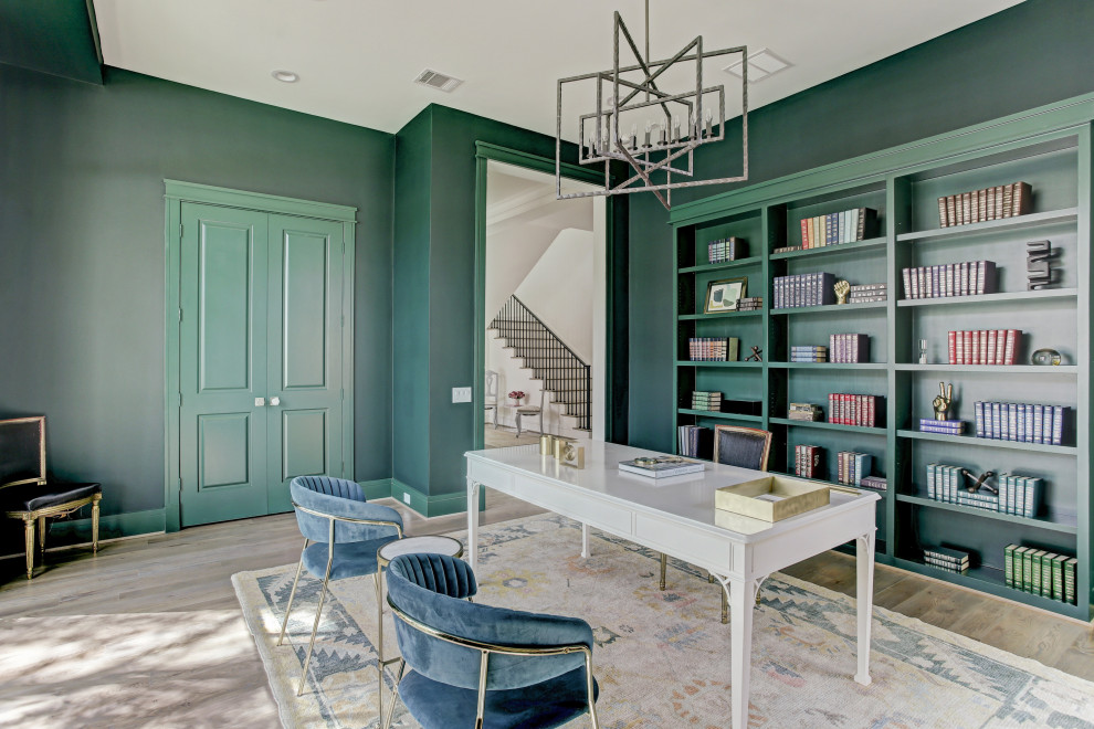 Photo of a transitional study room in Houston with green walls, light hardwood floors, a freestanding desk and beige floor.