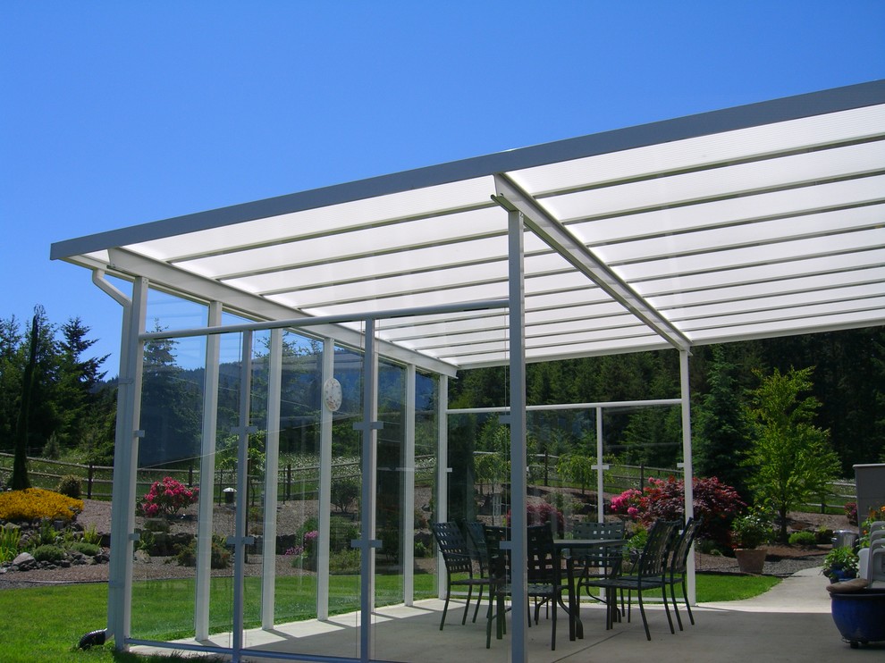 Inspiration for a mid-sized country backyard patio in Seattle with concrete slab and an awning.