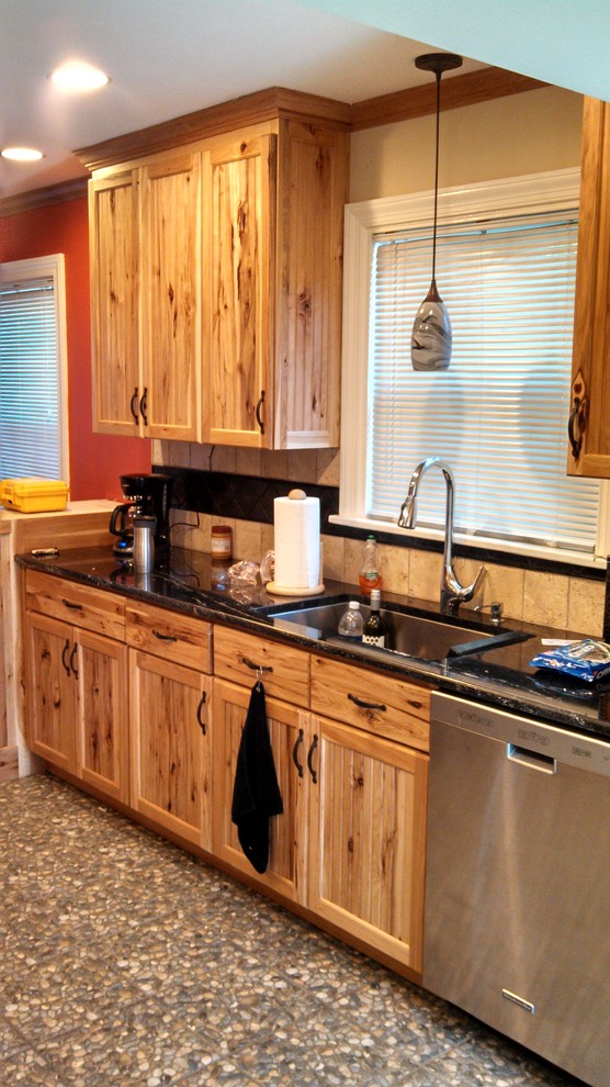 Inspiration for a mid-sized rustic l-shaped porcelain tile enclosed kitchen remodel in Richmond with an undermount sink, recessed-panel cabinets, medium tone wood cabinets, granite countertops, beige backsplash, ceramic backsplash, stainless steel appliances, yellow walls and a peninsula