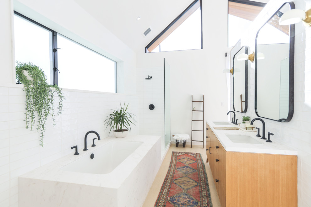 Photo of a contemporary master bathroom in Los Angeles with flat-panel cabinets, light wood cabinets, an undermount tub, an open shower, white tile, white walls, an undermount sink, beige floor, an open shower and light hardwood floors.
