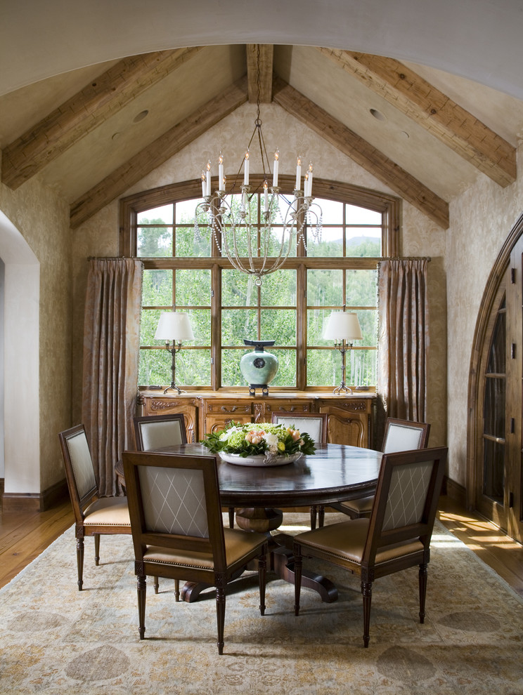 Photo of a country dining room in Denver with beige walls and dark hardwood floors.