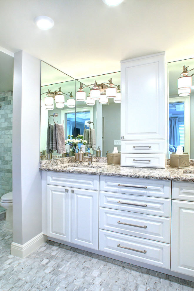 Photo of a large traditional 3/4 bathroom in Miami with raised-panel cabinets, white cabinets, an alcove shower, gray tile, marble, grey walls, marble floors, granite benchtops, grey floor, a hinged shower door, brown benchtops, a double vanity and a built-in vanity.