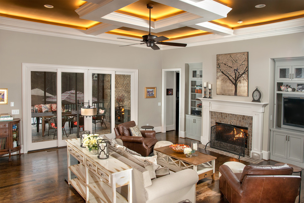 Inspiration for a large traditional formal open concept living room in Other with beige walls, dark hardwood floors, a standard fireplace and a built-in media wall.