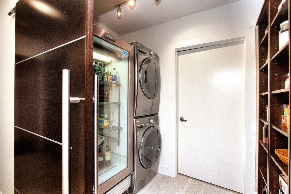 Mid-sized transitional galley utility room in Miami with open cabinets, dark wood cabinets, white walls, porcelain floors, a stacked washer and dryer and grey floor.