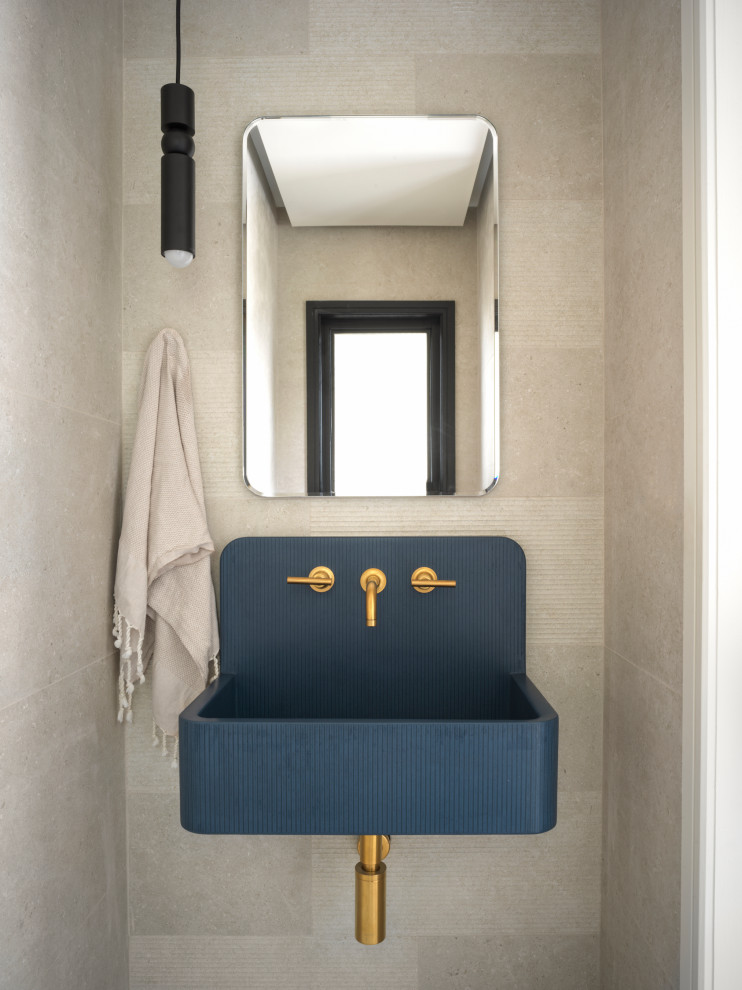 This is an example of a modern cloakroom in New York with open cabinets, beige tiles, a wall-mounted sink, concrete worktops, blue worktops and a floating vanity unit.