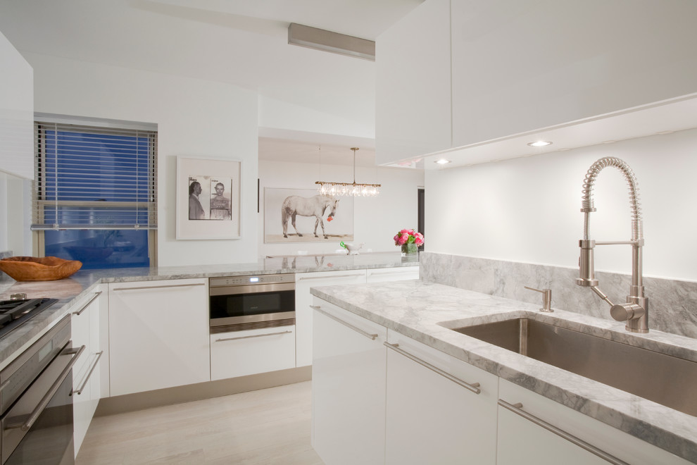 Photo of a contemporary kitchen in New York with stainless steel appliances and granite benchtops.