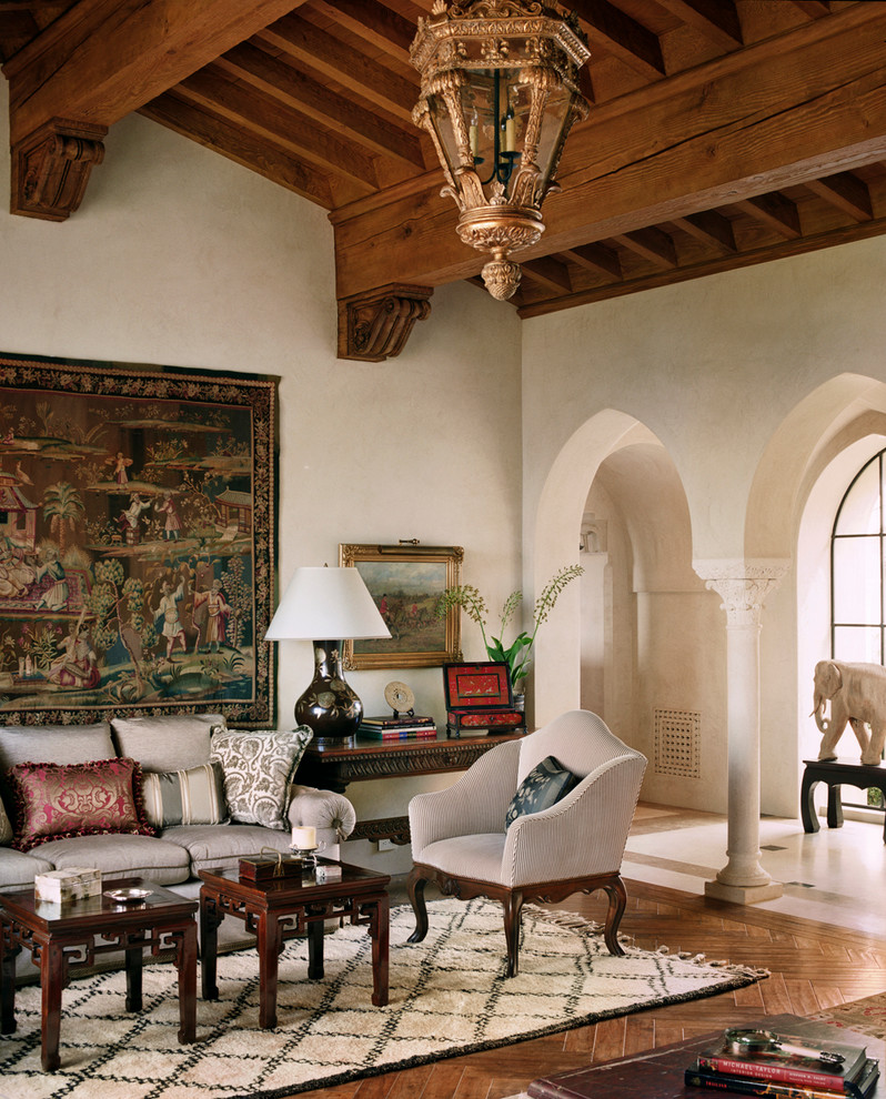This is an example of a mediterranean living room in San Francisco with beige walls, medium hardwood floors and no tv.