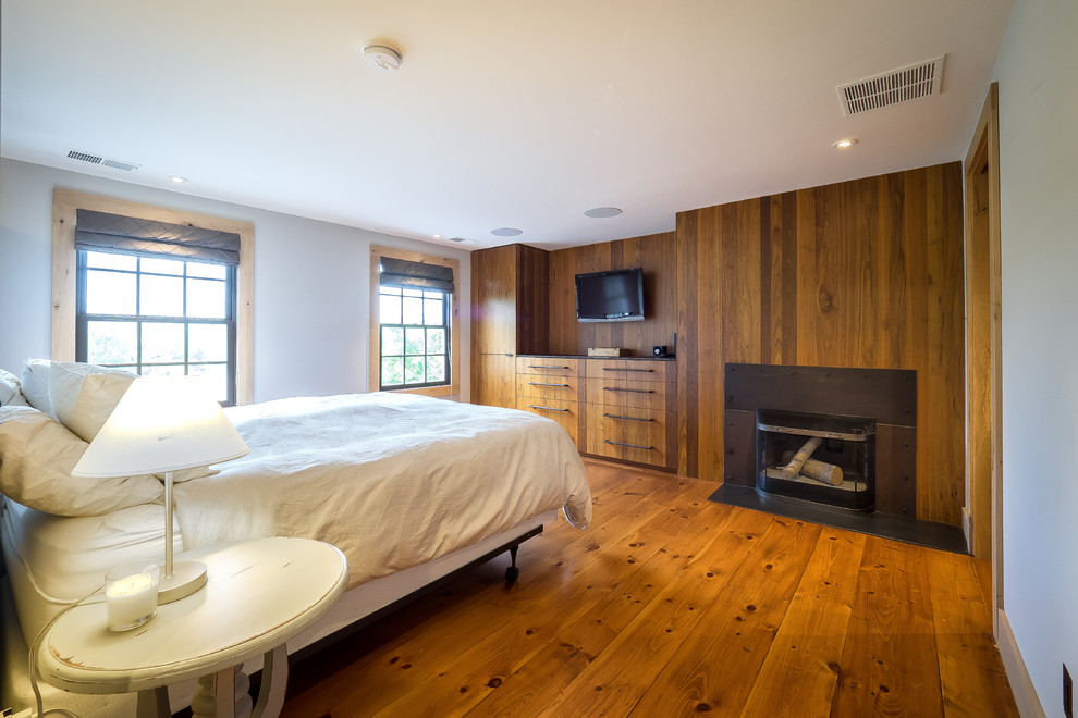 Inspiration for a mid-sized country master bedroom in Philadelphia with white walls, marble floors, white floor, a standard fireplace and a metal fireplace surround.