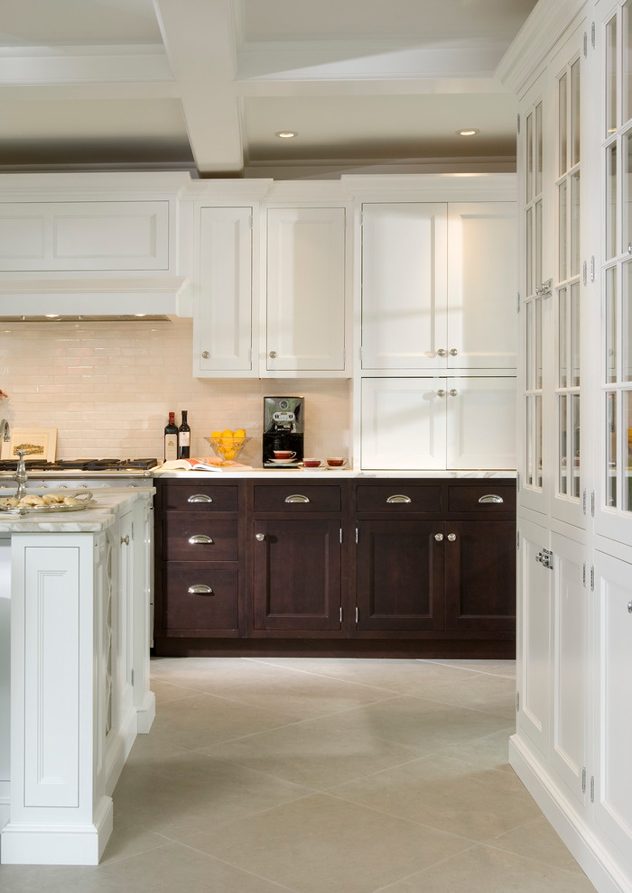 This is an example of a traditional u-shaped eat-in kitchen in New York with an undermount sink, recessed-panel cabinets, white cabinets, marble benchtops, white splashback, ceramic splashback and stainless steel appliances.