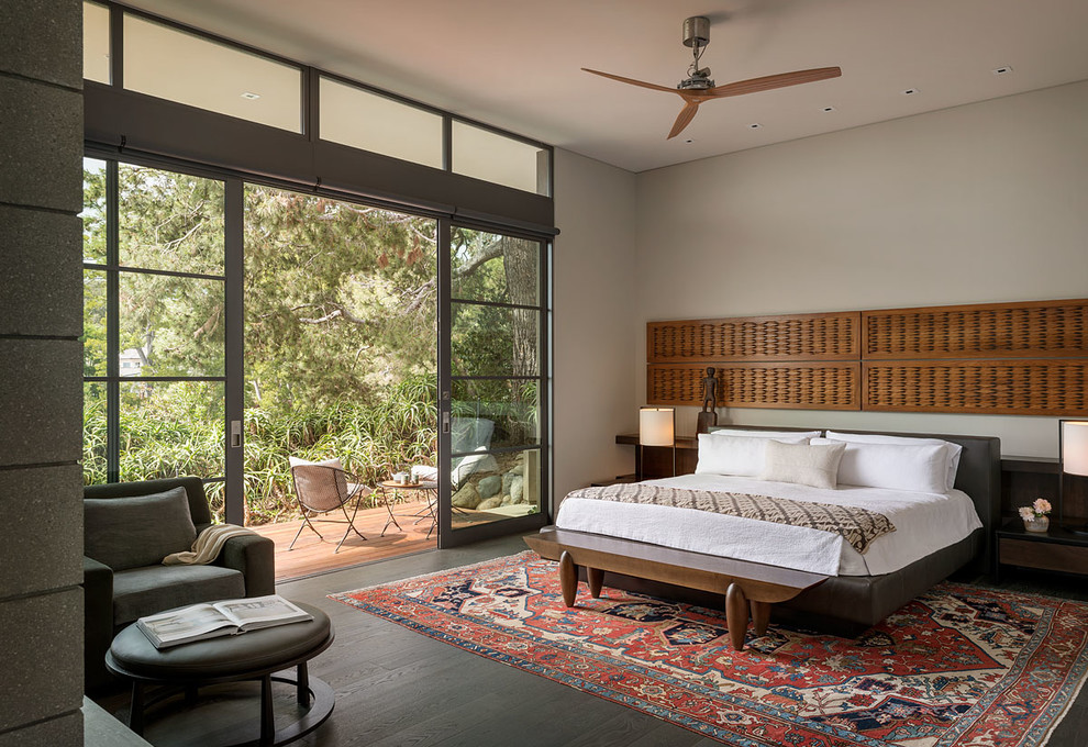 Photo of a midcentury master bedroom in Orange County with grey walls and dark hardwood floors.