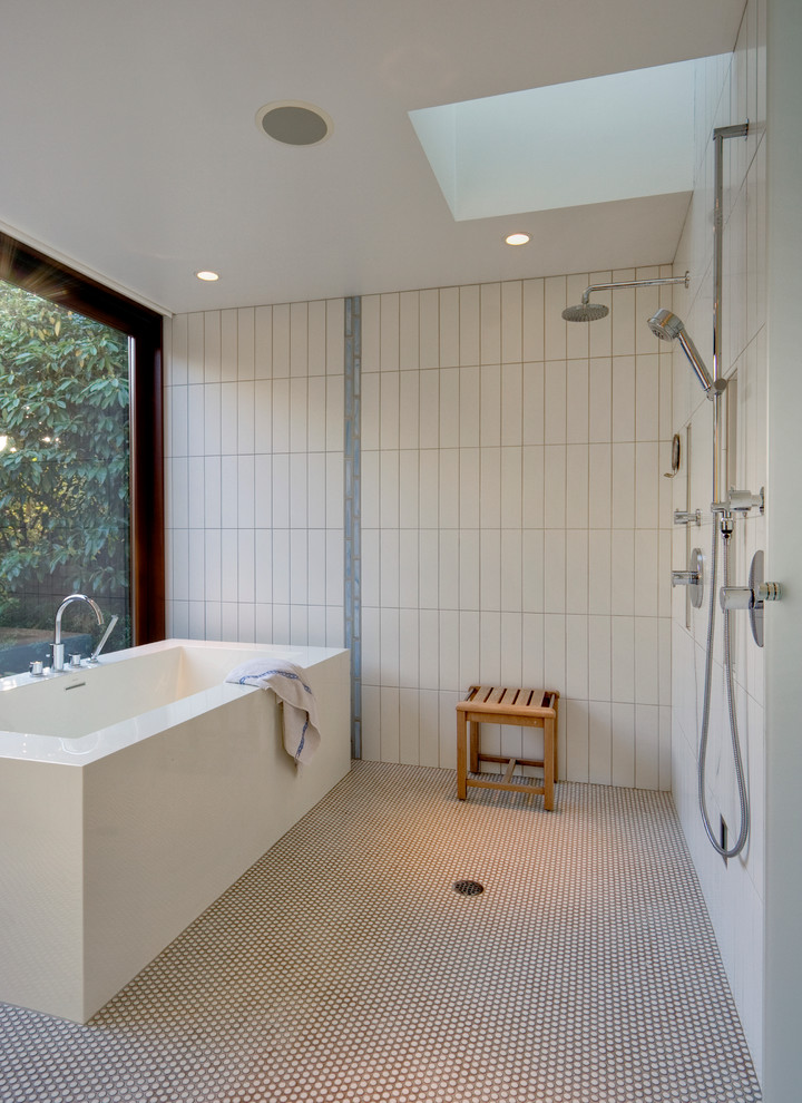 Inspiration for a modern bathroom in Seattle with a freestanding tub, white tile, mosaic tile floors and a curbless shower.