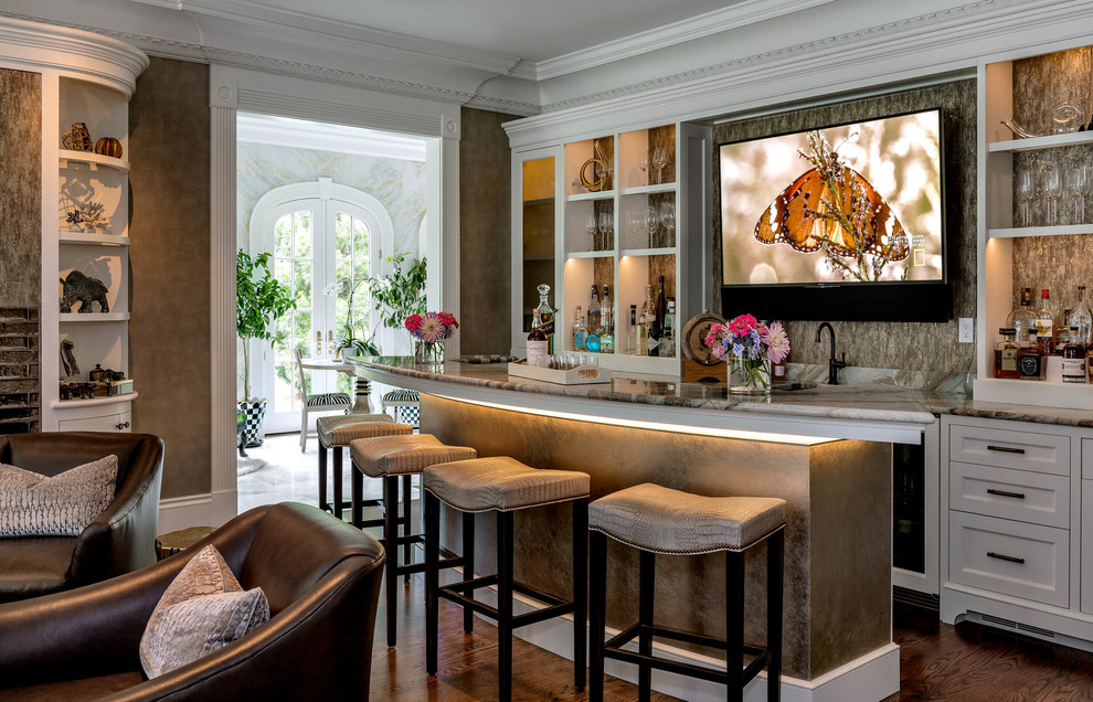 Photo of a mid-sized traditional single-wall seated home bar in Boston with shaker cabinets, white cabinets, granite benchtops, brown splashback, dark hardwood floors, brown floor and brown benchtop.