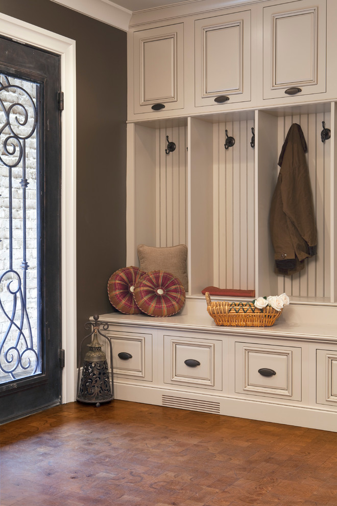 This is an example of a mid-sized traditional mudroom in Atlanta with brown walls, a single front door and a glass front door.