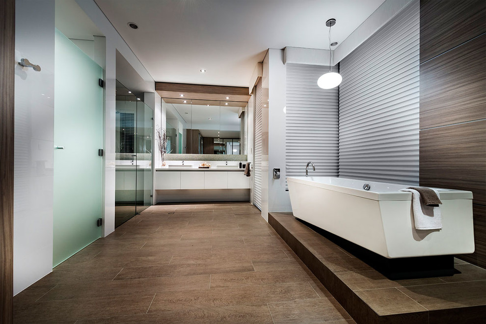 Design ideas for a contemporary master bathroom in Perth with flat-panel cabinets, white cabinets, a freestanding tub, brown tile, white walls, a drop-in sink and a hinged shower door.