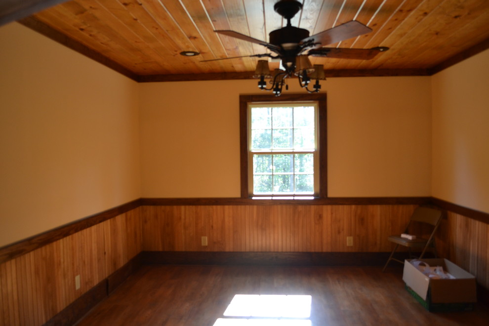 Kitchen - mid-sized rustic u-shaped medium tone wood floor kitchen idea in Atlanta with raised-panel cabinets, brown cabinets, granite countertops, stainless steel appliances and an island