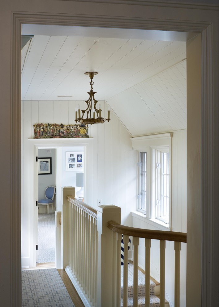 Traditional hallway in New York with white walls and medium hardwood floors.