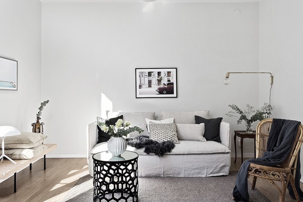Photo of a mid-sized scandinavian living room in Gothenburg with grey walls, medium hardwood floors and brown floor.