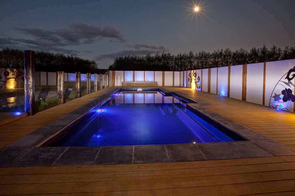 This is an example of a large contemporary backyard rectangular lap pool in Melbourne with decking.