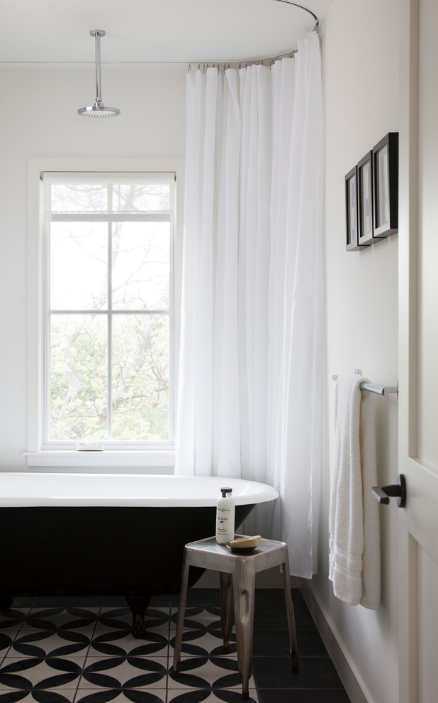 Inspiration for a scandinavian 3/4 bathroom in Austin with marble benchtops, a claw-foot tub, a shower/bathtub combo, a one-piece toilet and porcelain floors.