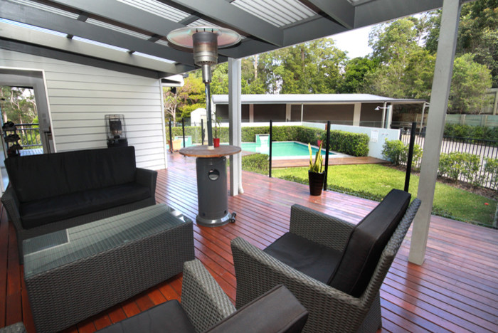 Inspiration for a large traditional backyard deck in Sunshine Coast with a roof extension.
