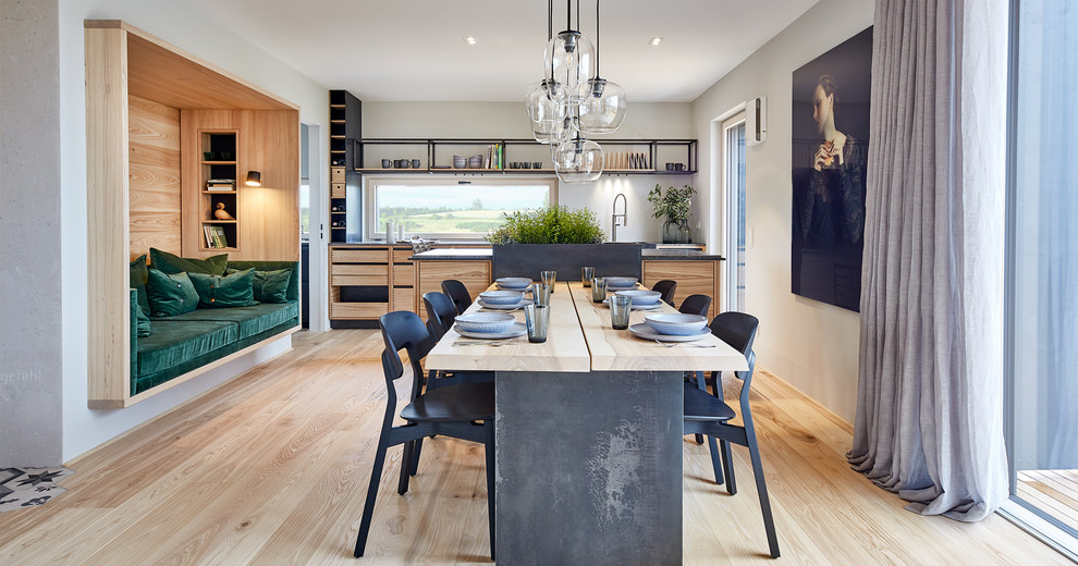 This is an example of a large contemporary kitchen/dining combo in Other with grey walls, no fireplace, light hardwood floors and beige floor.