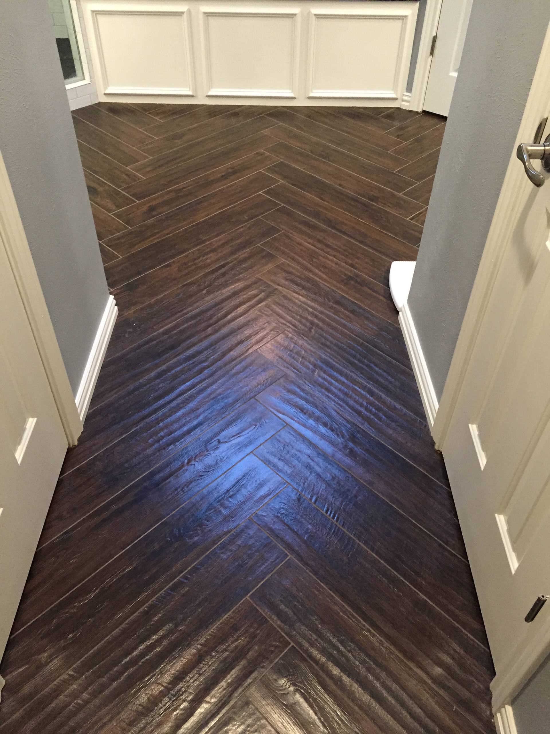 Master bath in Murphy complete remodel with walk in shower, herring bone plank tile flooring, drop in tub with craftsman style face, custom tile work with large mosaic piece and pan design.