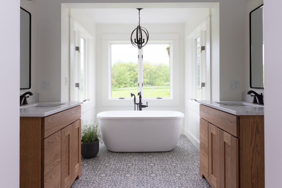 This is an example of a mid-sized country master bathroom in Other with flat-panel cabinets, light wood cabinets, a freestanding tub, a corner shower, white walls, mosaic tile floors, a drop-in sink, quartzite benchtops, multi-coloured floor, a hinged shower door and white benchtops.