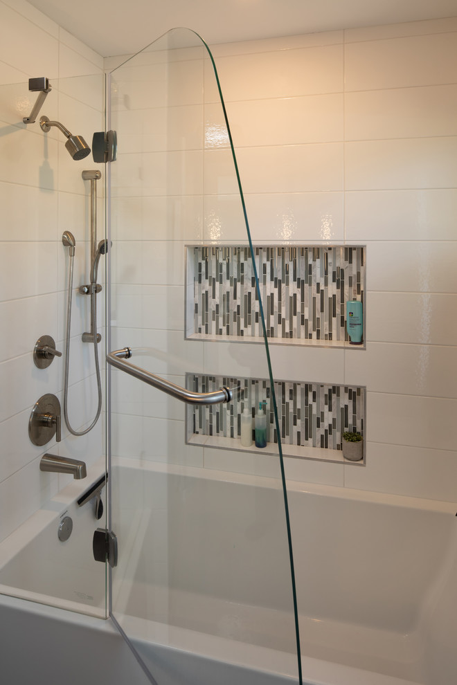 Large midcentury master bathroom in Minneapolis with flat-panel cabinets, medium wood cabinets, a shower/bathtub combo, blue walls, ceramic floors, an undermount sink, granite benchtops, beige floor, a hinged shower door and white benchtops.