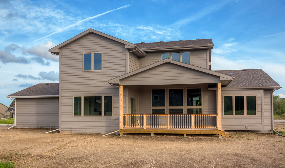 Inspiration for a transitional backyard deck remodel with a roof extension