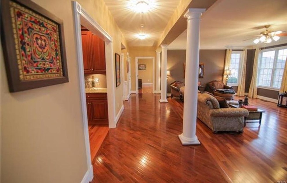 This is an example of a large traditional hallway in Philadelphia with grey walls, dark hardwood floors and multi-coloured floor.