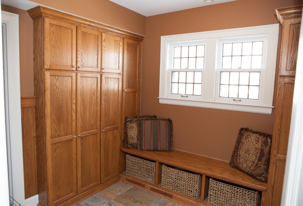Small traditional mudroom in Chicago with brown walls, porcelain floors and a single front door.