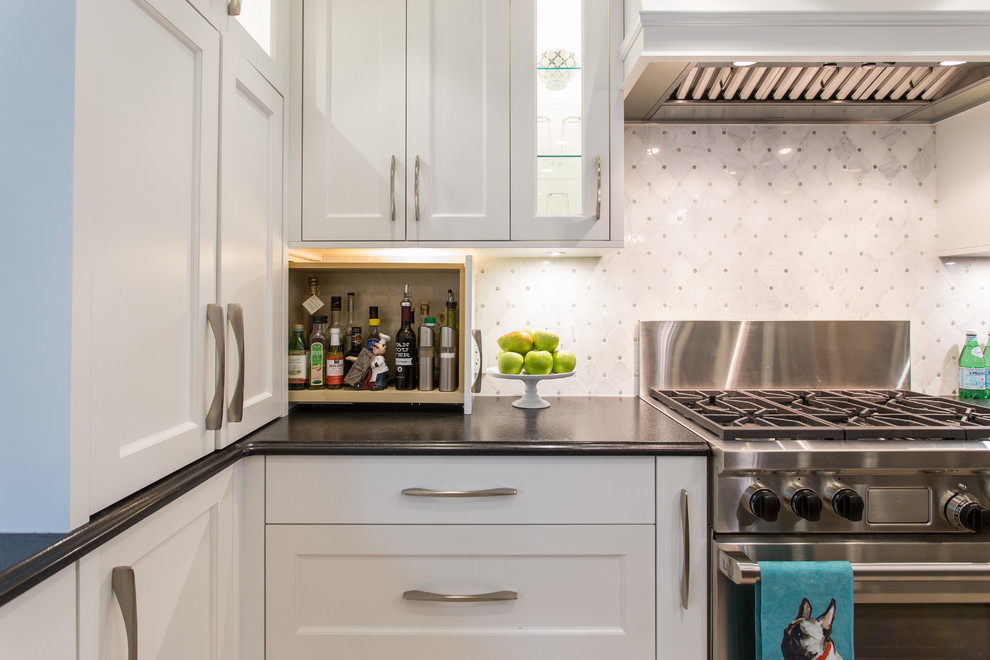 Inspiration for a large transitional l-shaped medium tone wood floor and beige floor eat-in kitchen remodel in Vancouver with an undermount sink, shaker cabinets, white cabinets, granite countertops, gray backsplash, marble backsplash, stainless steel appliances, an island and black countertops