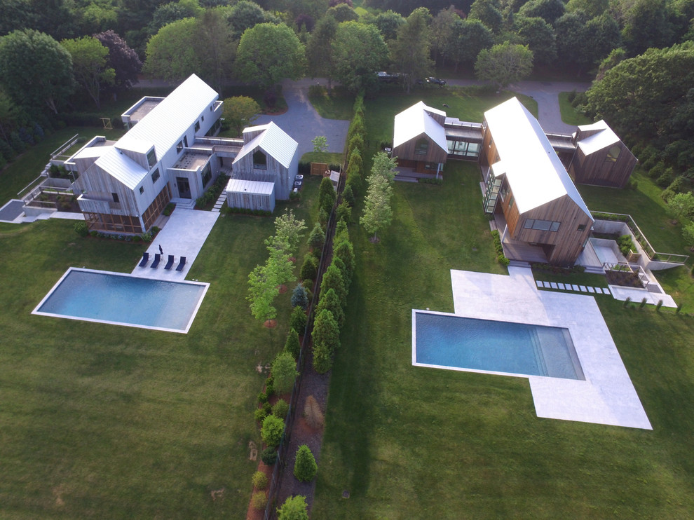 Example of a large backyard stone and rectangular aboveground pool design in New York