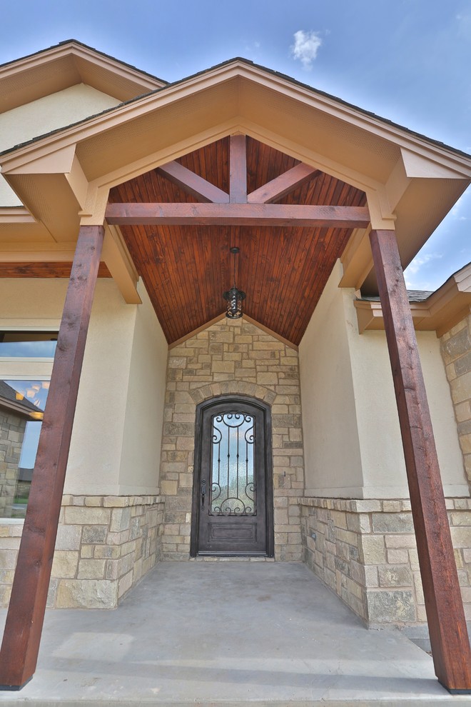 Example of a mid-sized mountain style concrete floor front door design in Dallas with metallic walls and a metal front door