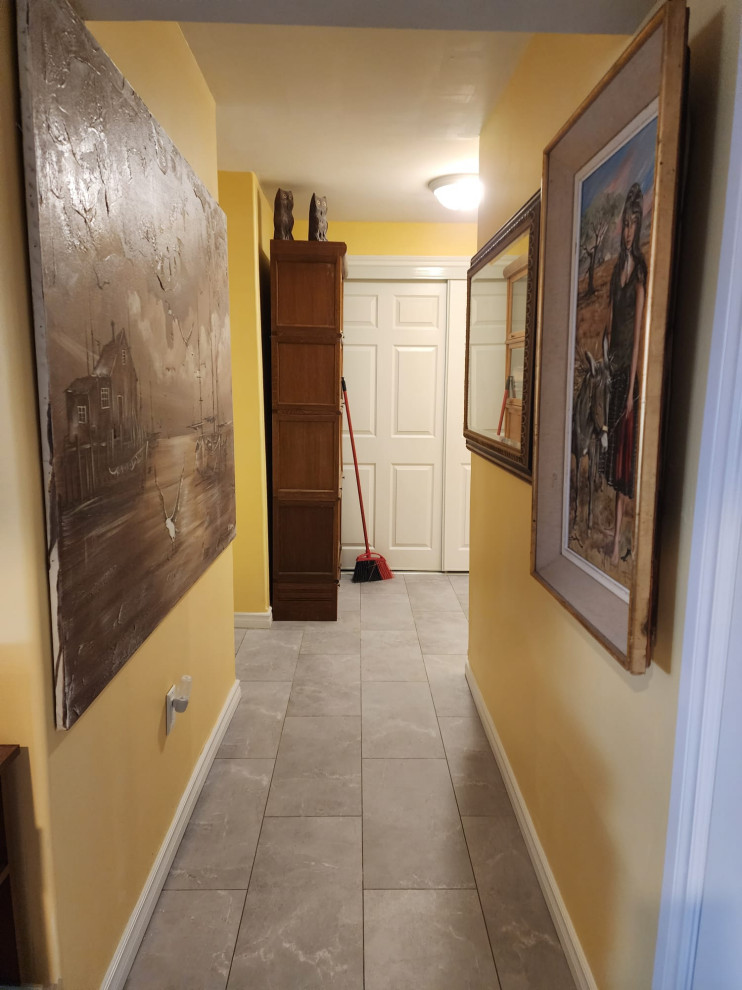 Mid-sized modern hallway in Other with yellow walls, vinyl floors and grey floor.