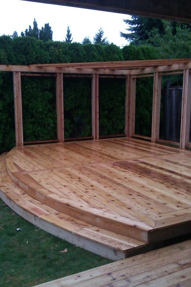 Mid-sized backyard deck photo in Vancouver with a pergola