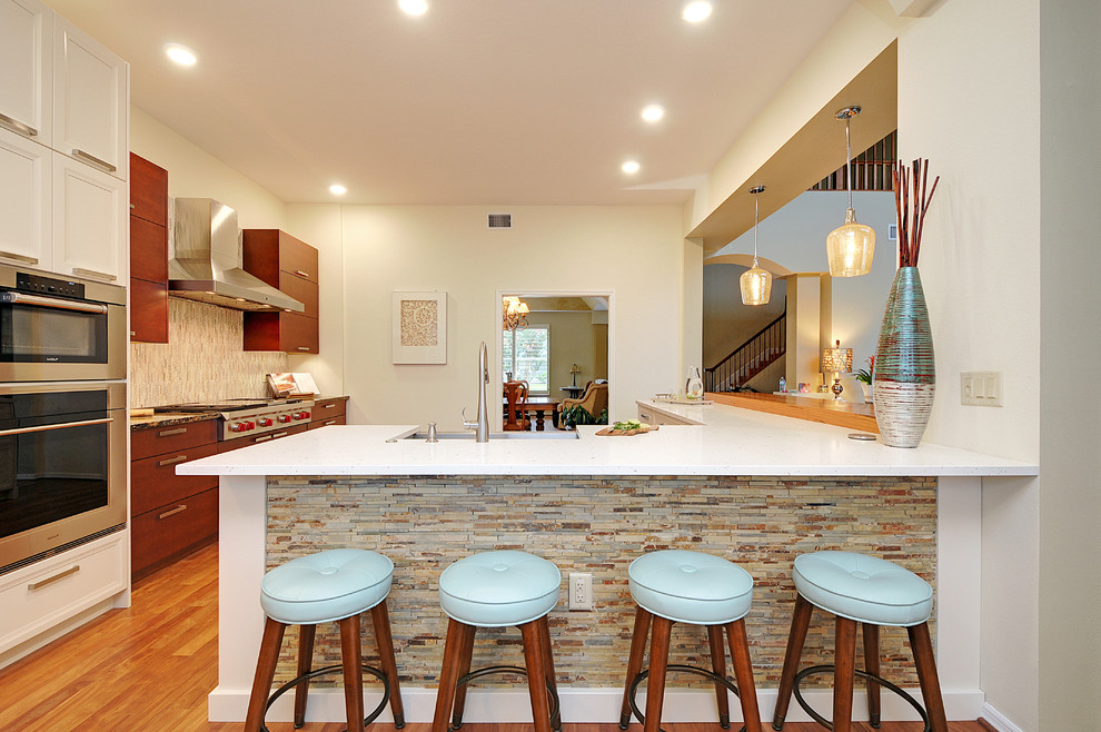 Inspiration for a large transitional l-shaped dark wood floor open concept kitchen remodel in Tampa with a farmhouse sink, gray backsplash, matchstick tile backsplash, stainless steel appliances and an island