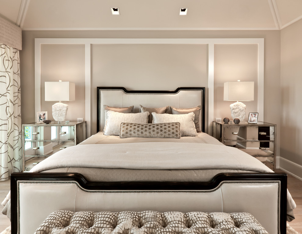 Inspiration for a transitional bedroom in Miami with beige walls and light hardwood floors.