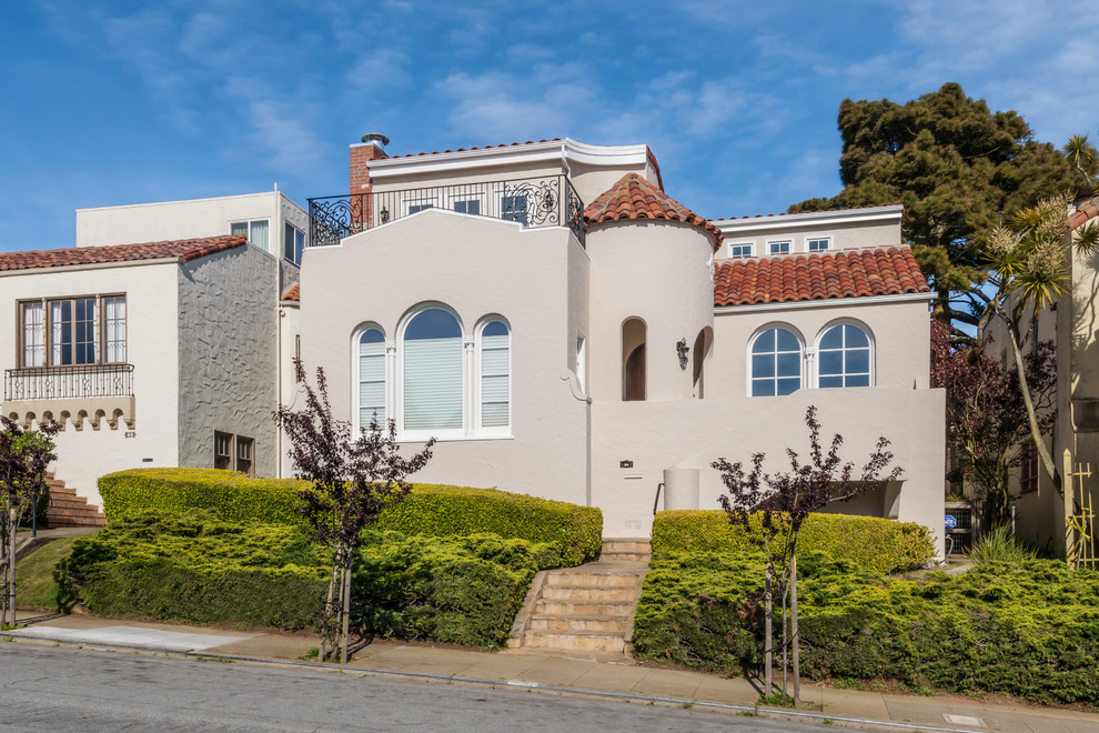 This is an example of a mediterranean two-storey beige exterior in San Francisco.